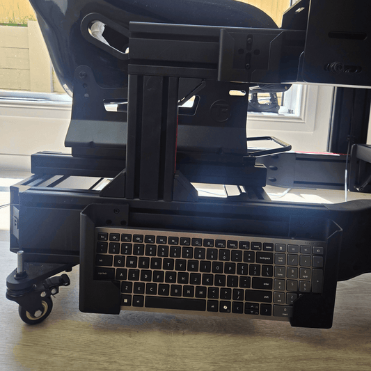 Keyboard Holder for Sim Rigs mounted under a racing cockpit, providing easy access to the keyboard.