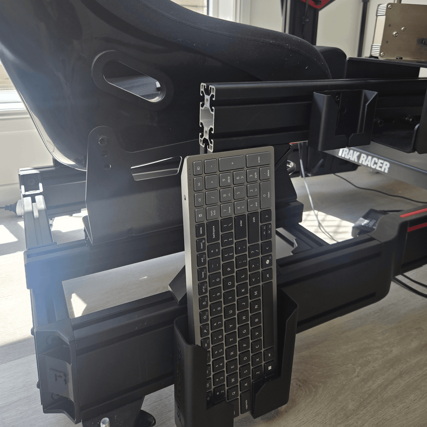 Keyboard Holder for Sim Rigs mounted on an aluminium profile, holding a keyboard for easy access during racing.