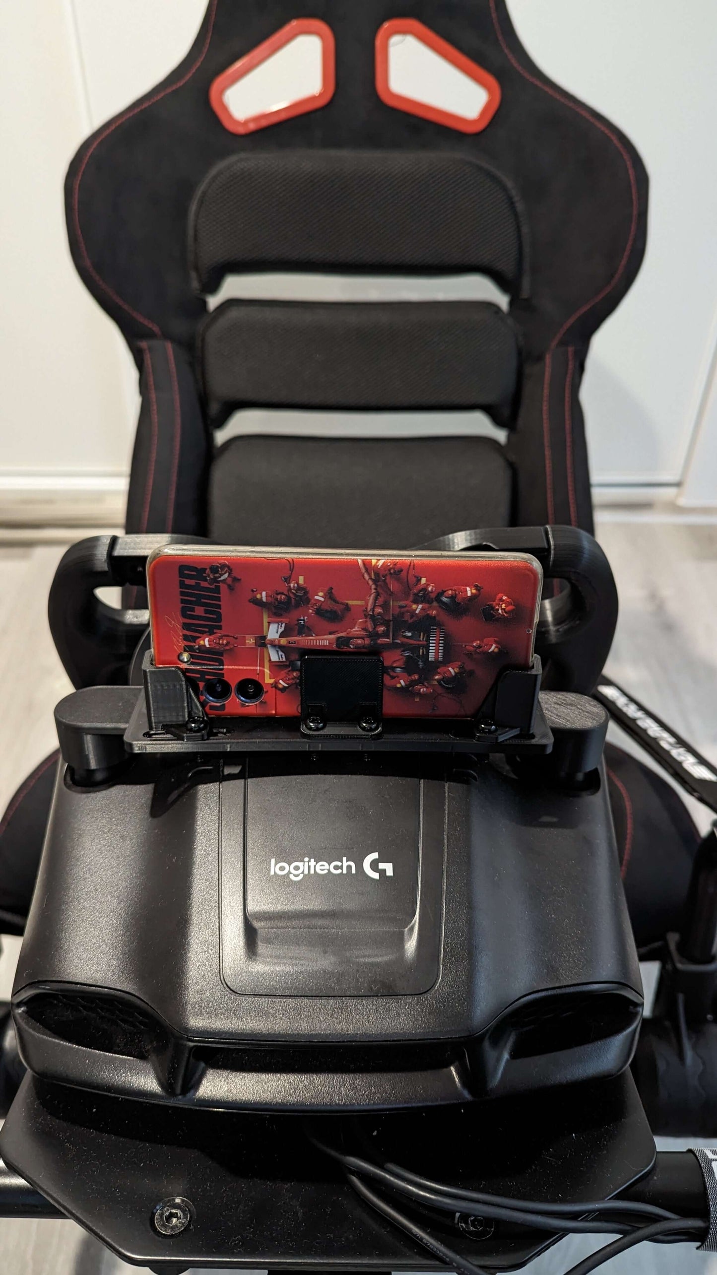 Dashboard Phone Holder Mod for Logitech racing wheels, securing smartphone for real-time race data.